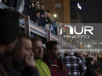 People are watching while standing at the site of the fire at the Gandhi hotel hospital in northern Tehran, Iran, on January 25, 2024. Patie...