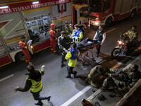 Iranian medical personnel are carrying a patient on a stretcher during a fire at the Gandhi hotel hospital in northern Tehran, Iran, on Janu...