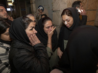 Relatives of a patient are gathering at the site of the fire at the Gandhi Hotel Hospital in northern Tehran, Iran, on January 25, 2024. Pat...