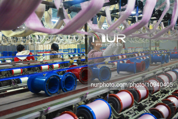 A worker is making silk products on a production line at a workshop of a silk production enterprise in Anqing, China, on January 26, 2024. 