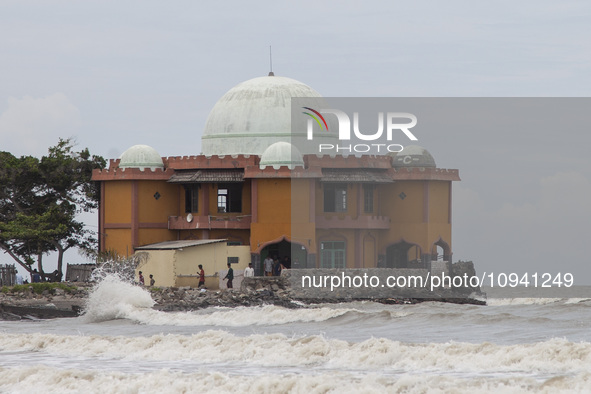 Residents are leaving the mosque after performing Friday prayers amidst high waves in Cemarajaya Village, Karawang Regency, West Java Provin...