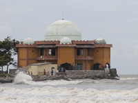 Residents are leaving the mosque after performing Friday prayers amidst high waves in Cemarajaya Village, Karawang Regency, West Java Provin...