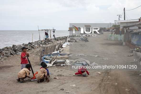 Children are playing on the village street right on the beach in Cemarajaya Village, Karawang Regency, West Java Province, on January 26, 20...