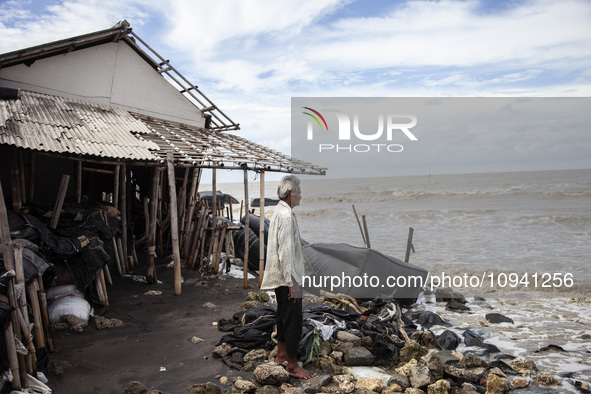 Carmat, 83, is staring out to sea near the remains of his house, which was destroyed by high waves in Cemarajaya Village, Karawang Regency,...