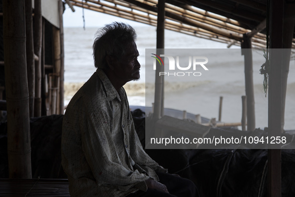 Carmat, 83, is staring out to sea near the remains of his house, which was destroyed by high waves in Cemarajaya Village, Karawang Regency,...