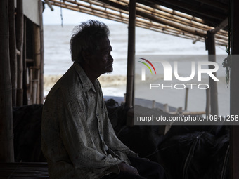 Carmat, 83, is staring out to sea near the remains of his house, which was destroyed by high waves in Cemarajaya Village, Karawang Regency,...