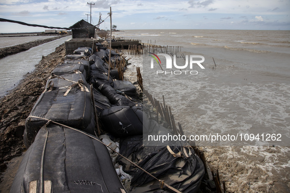 Giant sandbags that are being used as embankments to prevent erosion are being damaged after being hit by waves in Cemarajaya Village, Karaw...