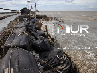 Giant sandbags that are being used as embankments to prevent erosion are being damaged after being hit by waves in Cemarajaya Village, Karaw...