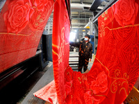 A worker is working on the production line of a warp knitting workshop at Yingyou Blanket Company in Lianyungang, China, on January 27, 2024...