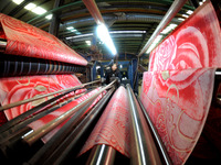 A worker is working on the production line of a warp knitting workshop at Yingyou Blanket Company in Lianyungang, China, on January 27, 2024...