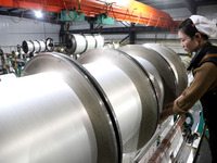 A worker is working on the production line of a warp knitting workshop at Yingyou Blanket Company in Lianyungang, China, on January 27, 2024...