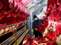 A worker is working on the production line of a warp knitting workshop at Yingyou Blanket Company in Lianyungang, China, on January 27, 2024...