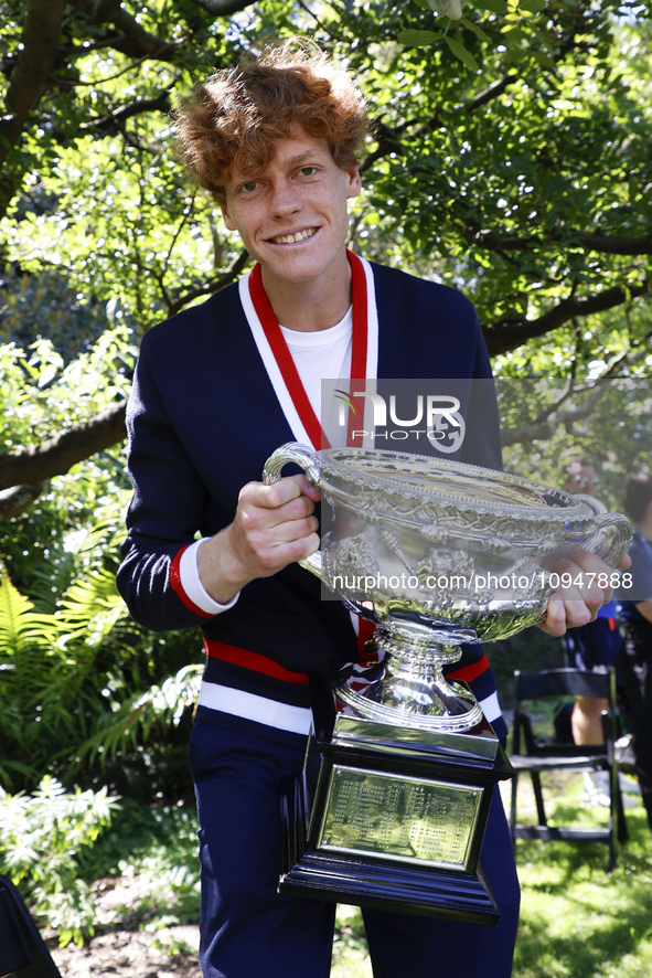 Jannik Sinner of Italy is posing with the Norman Brookes Challenge Cup after winning the 2024 Australian Open Final at the Royal Botanic Gar...