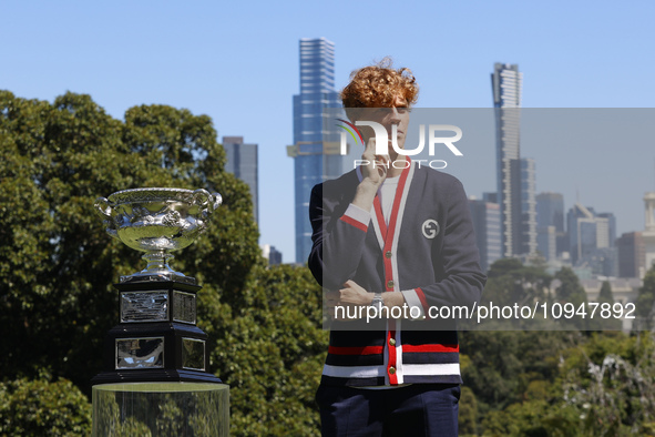 Jannik Sinner of Italy is posing with the Norman Brookes Challenge Cup after winning the 2024 Australian Open Final at the Royal Botanic Gar...