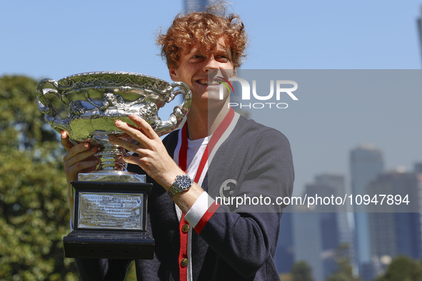 Jannik Sinner of Italy is posing with the Norman Brookes Challenge Cup after winning the 2024 Australian Open Final at the Royal Botanic Gar...