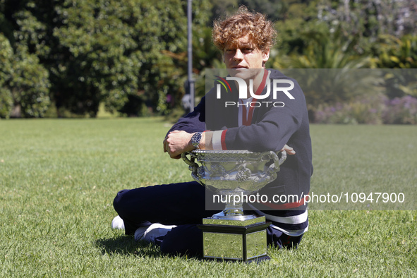 Jannik Sinner of Italy is posing with the Norman Brookes Challenge Cup after winning the 2024 Australian Open Final at the Royal Botanic Gar...