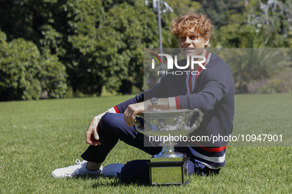 Jannik Sinner of Italy is posing with the Norman Brookes Challenge Cup after winning the 2024 Australian Open Final at the Royal Botanic Gar...