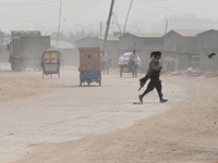 People Make Their Move In A Dusty Busy Road In Dhaka City, Bangladesh, On January 30, 2024. Dhaka City's Air Was Classified As 'very Unhealt...