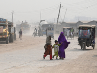 People Make Their Move In A Dusty Busy Road In Dhaka City, Bangladesh, On January 30, 2024. Dhaka City's Air Was Classified As 'very Unhealt...