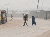 People Make Their Move In A Dusty Busy Road In Dhaka City, Bangladesh, On January 30, 2024. Dhaka City's Air Was Classified As 'very Unhealt...