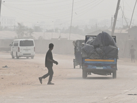 People Make Their Move In A Dusty Busy Road In Dhaka City, Bangladesh, On January 30, 2024. Dhaka City's Air Was Classified As 'very Unhealt...