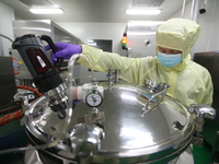 A worker is working on a drug production line at the production workshop of a pharmaceutical company in Meishan, China, on January 30, 2024....