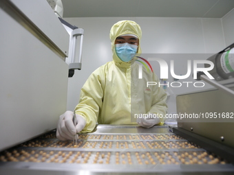 A worker is working on a drug production line at the production workshop of a pharmaceutical company in Meishan, China, on January 30, 2024....