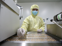 A worker is working on a drug production line at the production workshop of a pharmaceutical company in Meishan, China, on January 30, 2024....