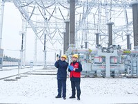 Power workers are carrying out a post-snow inspection of power supply equipment at a 500-kilovolt substation in Meizhuang village, Chuzhou c...