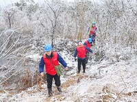 Electric workers are patrolling power supply lines after snow in Meizhou village, Chuzhou, China, on February 4, 2024. (