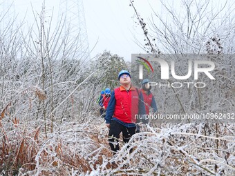 Electric workers are patrolling power supply lines after snow in Meizhou village, Chuzhou, China, on February 4, 2024. (