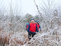 Electric workers are patrolling power supply lines after snow in Meizhou village, Chuzhou, China, on February 4, 2024. (