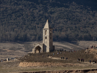 Hundreds of people are visiting the old town of Sant Roma de Sau, where normally the water of the Sau reservoir would almost completely cove...