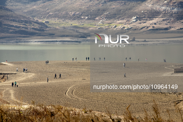 Hundreds of people are visiting the old town of Sant Roma de Sau, where normally the water of the Sau reservoir would almost completely cove...