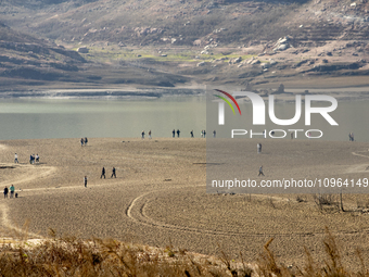 Hundreds of people are visiting the old town of Sant Roma de Sau, where normally the water of the Sau reservoir would almost completely cove...