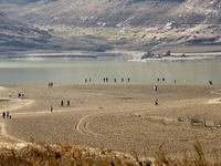 Hundreds of people are visiting the old town of Sant Roma de Sau, where normally the water of the Sau reservoir would almost completely cove...