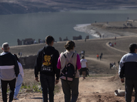 Hundreds of people are visiting the old town of Sant Roma de Sau, where normally the water of the Sau reservoir would almost completely cove...