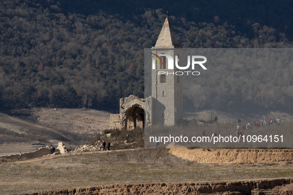 Hundreds of people are visiting the old town of Sant Roma de Sau, where normally the water of the Sau reservoir would almost completely cove...