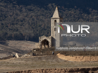 Hundreds of people are visiting the old town of Sant Roma de Sau, where normally the water of the Sau reservoir would almost completely cove...