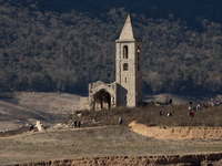 Hundreds of people are visiting the old town of Sant Roma de Sau, where normally the water of the Sau reservoir would almost completely cove...