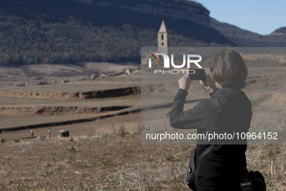 Hundreds of people are visiting the old town of Sant Roma de Sau, where normally the water of the Sau reservoir would almost completely cove...