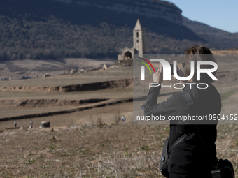 Hundreds of people are visiting the old town of Sant Roma de Sau, where normally the water of the Sau reservoir would almost completely cove...