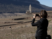 Hundreds of people are visiting the old town of Sant Roma de Sau, where normally the water of the Sau reservoir would almost completely cove...