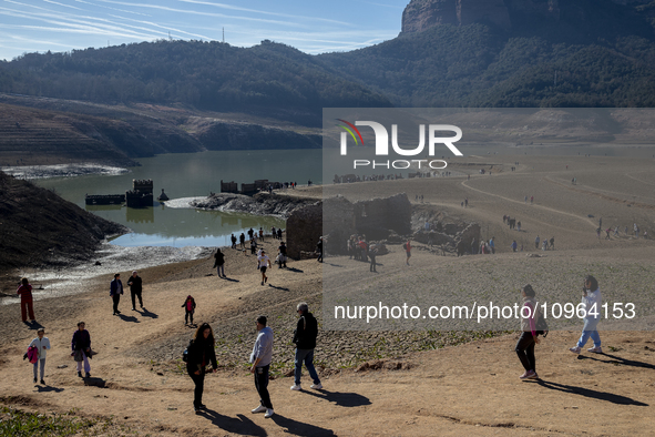 Hundreds of people are visiting the old town of Sant Roma de Sau, where normally the water of the Sau reservoir would almost completely cove...