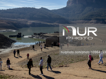 Hundreds of people are visiting the old town of Sant Roma de Sau, where normally the water of the Sau reservoir would almost completely cove...