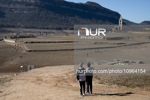 Hundreds of people are visiting the old town of Sant Roma de Sau, where normally the water of the Sau reservoir would almost completely cove...