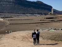 Hundreds of people are visiting the old town of Sant Roma de Sau, where normally the water of the Sau reservoir would almost completely cove...