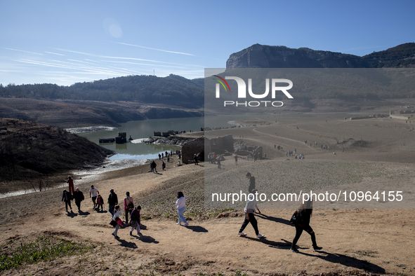 Hundreds of people are visiting the old town of Sant Roma de Sau, where normally the water of the Sau reservoir would almost completely cove...