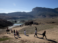 Hundreds of people are visiting the old town of Sant Roma de Sau, where normally the water of the Sau reservoir would almost completely cove...