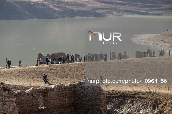 Hundreds of people are visiting the old town of Sant Roma de Sau, where normally the water of the Sau reservoir would almost completely cove...